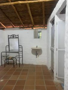 a bathroom with a chair and a sink in a room at Casa Victoria in Piedecuesta