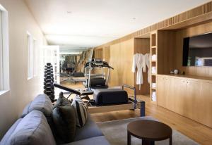 a living room with a couch and a gym at Hazelwood House in Mittagong