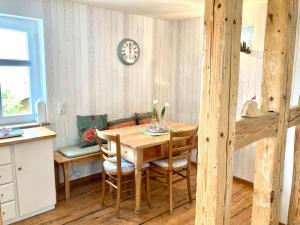 a dining room with a wooden table and chairs at Ferienhaus bei Juste in Schotten +16 photos