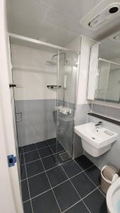 a bathroom with a shower and a sink at Central Height Apartment Royal in Busan +9 photos