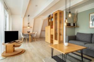 a living room with a couch and a table at Wikinger 74 in Immenstaad am Bodensee