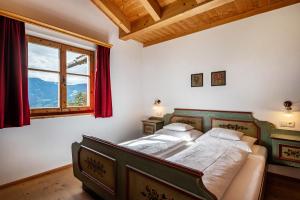 a bedroom with a bed and a large window at Biohof Maurer Apt Dorfblick in Laion
