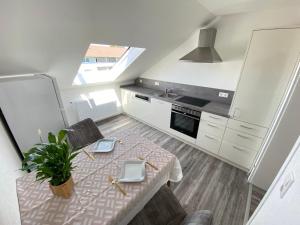 a small kitchen with a table and a sink at Haus Schwarzwald - Bad Krozingen in Bad Krozingen +34 photos