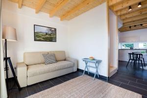 a living room with a couch and a table at Sun City Vízisport Paradicsom in Hódmezővásárhely