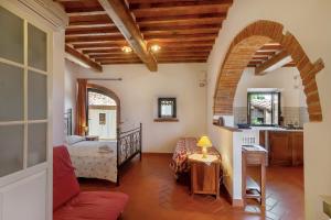a living room with a bed and a kitchen at Podere Papèra - Chianti hills in San Casciano in Val di Pesa +54 photos