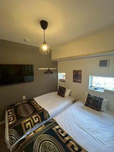 Postel nebo postele na pokoji v ubytování Higashi-Shinjuku 1002