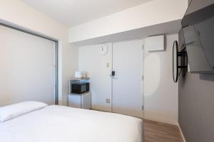 Postel nebo postele na pokoji v ubytování Higashi-Shinjuku 1002