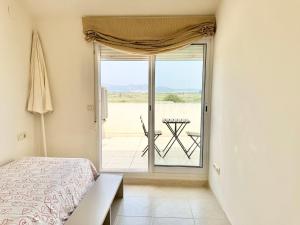 a bedroom with a bed and a view of a patio at Lopimar Playa Malvarrosa in Sagunto +33 photos