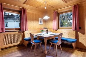 a wooden dining room with a table and chairs at Cesa Valeria App Sonia in Ortisei +18 photos