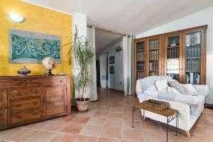 a living room with a couch and a table at Casa Su Craminu in Dorgali