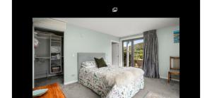 a bedroom with a bed and a window at Miners Lane Guest House in Clyde