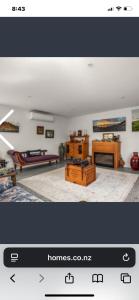 a picture of a living room with a couch and tables at Miners Lane Guest House in Clyde