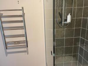 a shower with a towel rack in a bathroom at Miners Lane Guest House in Clyde +25 photos