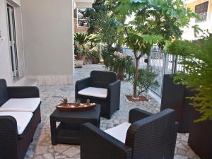 a patio with chairs and tables and trees at Alba D'Abruzzo Bed and Breakfast in Alba Adriatica