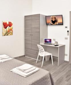 アルバ・アドリアティカにあるAlba D'Abruzzo Bed and Breakfastのベッドルーム1室(デスク、壁にコンピュータ付)