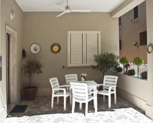 a dining room with a table and white chairs at Alba D'Abruzzo Bed and Breakfast in Alba Adriatica +2 photos