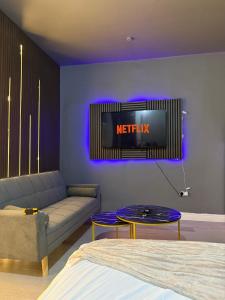 a living room with a couch and a tv at Starlight Nights in Bradford