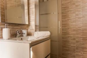 a bathroom with a sink and a shower at Casa Marisol in Pula +15 photos