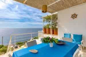 a blue table on a balcony with a view of the ocean at Perla sul mare Adriatico in Marittima