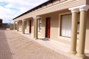 a row of columns on the side of a building at Morothong Guest Suites in Moremela
