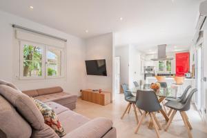 a living room with a couch and a table at Villa Bahia Azul in Llucmajor