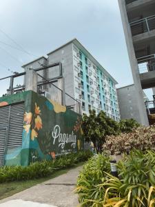 a building with a mural on the side of it at 90's Themed 2 Bedroom Unit at Seawind Sasa, Davao City Philippines in Sampong
