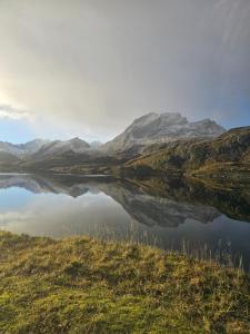 a reflection of a mountain in a body of water at Apartment at Lofoten. Mølnarodden. in Sund