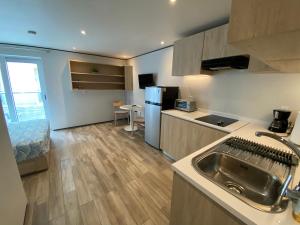 a kitchen with a sink and a counter top at Maho Escape- with Pool and Gym, Lagoon view, walk to Maho Beach and Mullet Bay, walk to dinning in Maho Reef