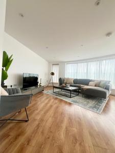 a living room with a couch and a tv at Luxury 2-Bed 2-Bath Penthouse with Terrace in Harrow