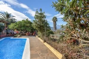 a pool in the backyard of a house with trees at Casa rural suerteluna in La Matanza de Acentejo