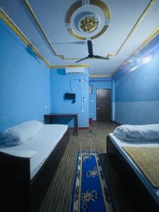 a room with two beds and a blue wall at Sunita Hotel And Lodge in Rāmechhāp