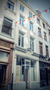 a white building with flags on the side of it at L'Epicentre in Brussels