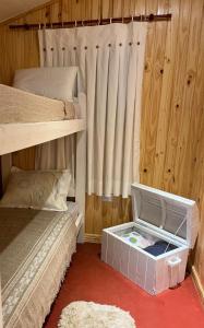 a bedroom with two bunk beds and a box on the floor at Casa Prusia, tipica de pioneros europeos in Aristóbulo del Valle