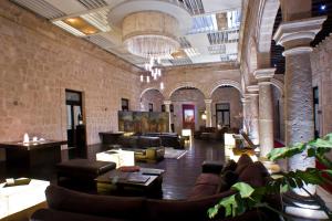 a large lobby with couches and chairs in a building at Cantera 10 Hotel Boutique in Morelia