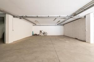 a garage with a bike parked in it at Nuovo Attico in Centro in Villasimius