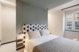 a bedroom with a bed and a window at Torri e tramonti in Albenga