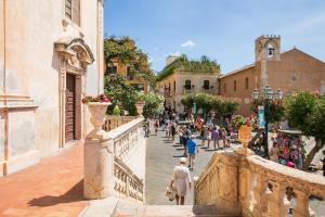 a group of people walking down a street at Casa Carly Taormina in Taormina