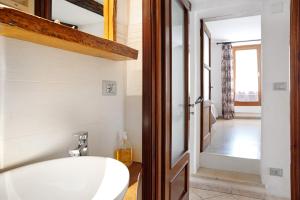 a bathroom with a white sink and a mirror at Pin e cele in Dronero