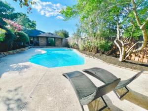 a patio with a chair and a swimming pool at Modern & Cozy house with pool in The Colony