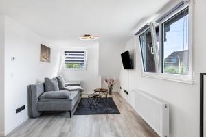 a living room with a couch and a window at Auszeit Matzi in Öhningen