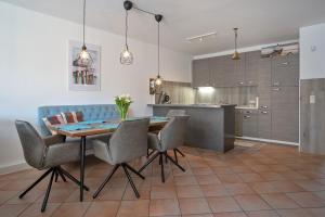 a kitchen and dining room with a table and chairs at Haus Biene am Meer in Norden