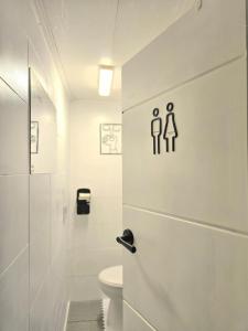 a white bathroom with a toilet and a sink at Namsan Nest in Seoul +51 photos