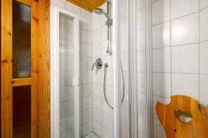 a shower with a shower head in a bathroom at Petite Maison des Alpes in Morgex +33 photos