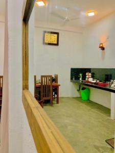 a room with a table and a clock on the wall at S97 Weligama in Weligama