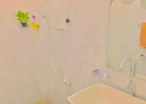 a bathroom with a shower with a sink and a mirror at S97 Weligama in Weligama