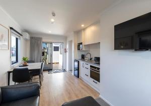a kitchen and living room with a table and a couch at Central Studios in Westport
