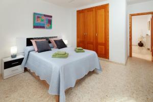 a bedroom with a bed with two towels on it at Apartamento Sugar Factory in Torre del Mar +21 photos