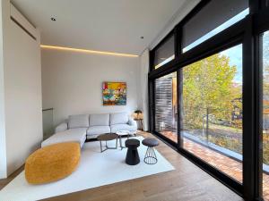 a living room with a couch and a large window at The Fount Niseko in Niseko