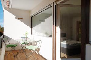 a room with a table and chairs on a balcony at Paulas Ferienwohnung in Füssen +7 photos