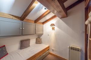 an attic room with a bed and a radiator at Appartement Pied Des Pistes in Crest-Voland